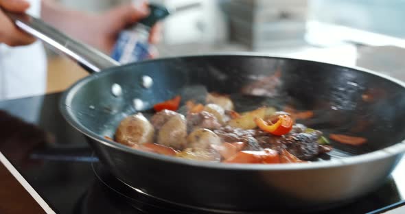 Cooking Frying Food with Fire Burning Vegetables on Pan By Flambe Method