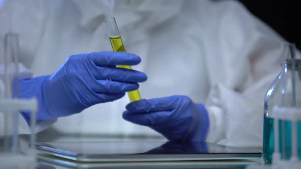 Lab Worker in Protective Suit Researching Flammable Sample of Fuel, Control alt