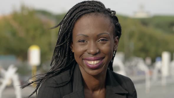 Beautiful young black american young woman smiling at camera-outdoor-slow motion alt