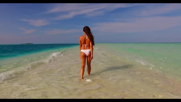 Lady tanning on exotic coast beach journey by clear ocean with white sand background of the Maldives alt