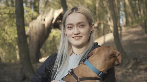 Close-up of Charming Blond Caucasian Woman with Pet Smiling at Camera. Portrait of Young Attractive alt