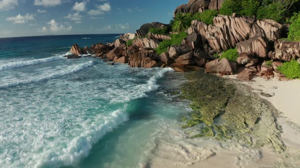 Aerial dolly close above the white sand Grand Anse beach, La Digue alt