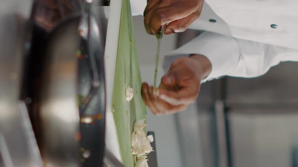 Vertical Video African American Cook Preparing Garlic Clove on Cutting Board alt