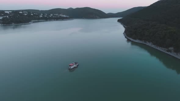 Flight Over the Lake and Over the Ferry to the Abrau Durso Under the Anapa Winery Sunset Day alt