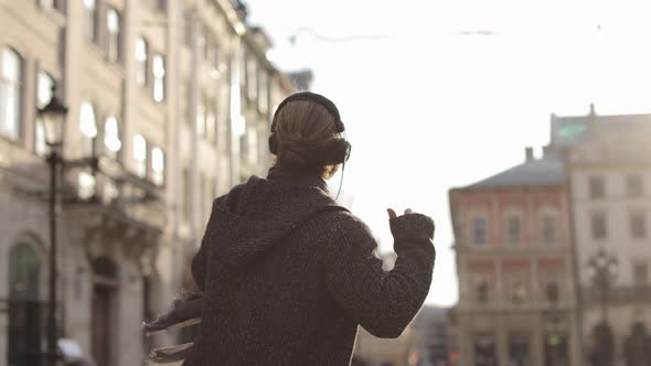 A Happy Bearded Man is Listening to Music and Emotionally Dancing alt