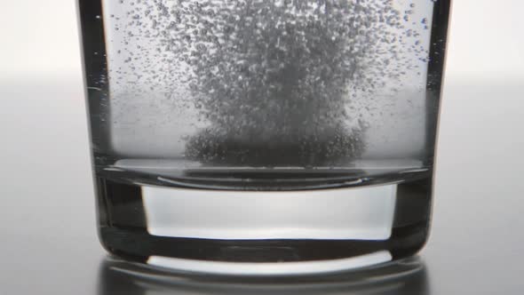 Effervescent Tablet Falls On A Bottom Of A Clear Glass alt