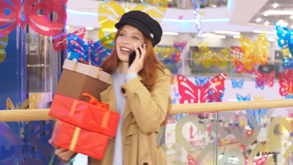 Portrait of Happy Shopaholic Girl in the Interior of Shopping Center, Emotionally Communicates on alt
