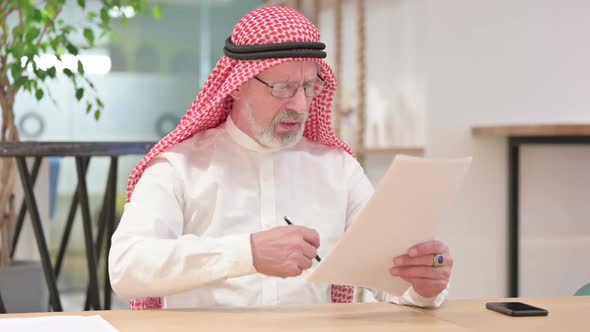 Senior Old Arab Businessman Having Failure on Documents alt