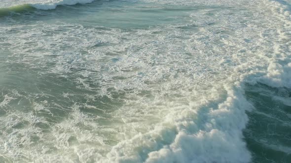 Beautiful White and Green Surfer Waves in Afternoon Light, Aerial Low Angle To Birds Eye View alt