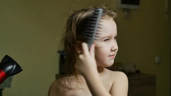 Cute Preschool Girl Blowdrying Her Hair After Bathing in the Bath
