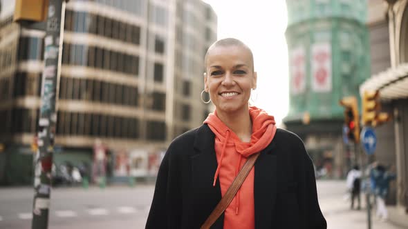 Smiling bald woman looking at the camera alt