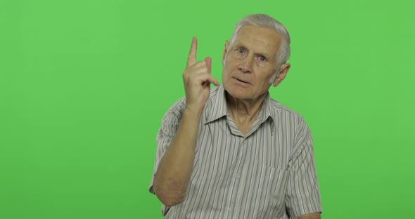 Senior Man Quarrels at Someone. Handsome Old Man on Chroma Key Background alt