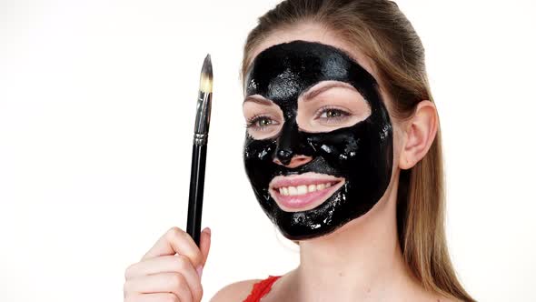 Girl with Black Peel Off Mask on Face