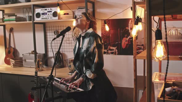 Cool Rock Girl Playing Piano And Singing alt