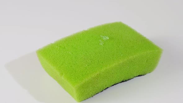 Super macro close-up shots of a green dish sponge and detergent filling.