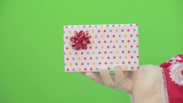 Santa Claus Hands Shake a Gift alt