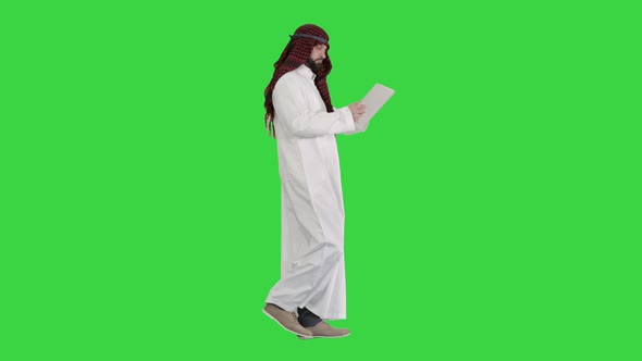 Sheikh Presenting Information or Product Using Digital Tablet on a Green Screen, Chroma Key. alt