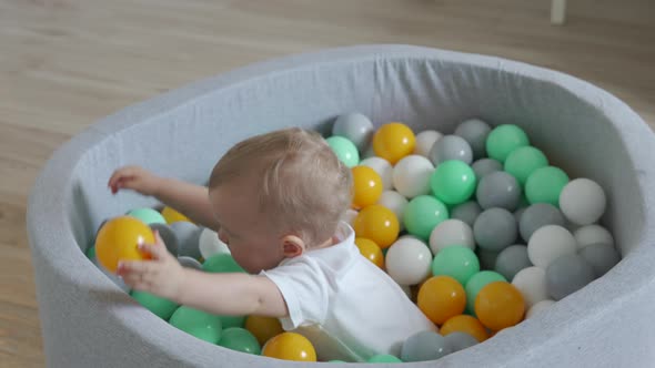 Kid Playing in Ball Pit at Home alt
