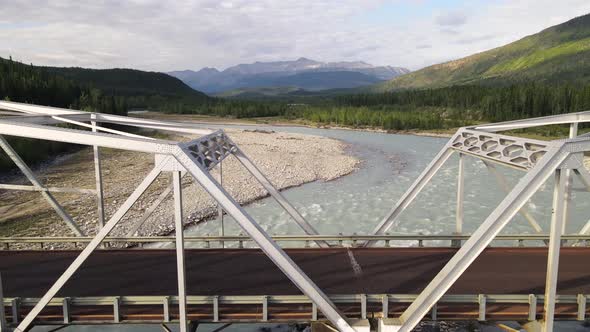 White bridge crossing the turquoises waters of Toad River in northern British Columbia, Canada. Aeri alt