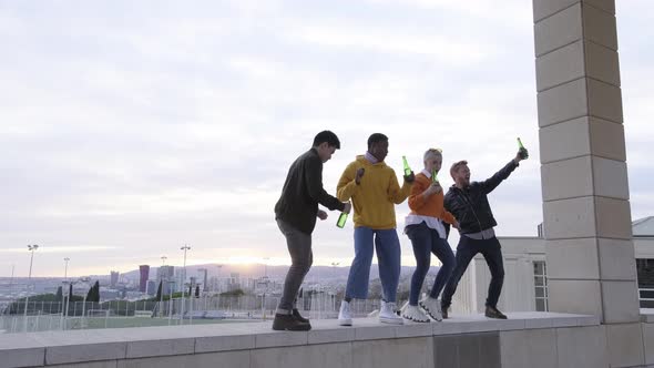 Happy multiracial friends having rooftop party