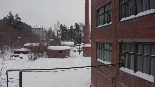 Brick Facade of the Industrial Building Against the Background of the Winter Landscape