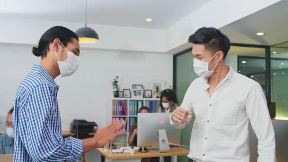 Group of Asian team business people working in office with new normal social distancing lifestyle alt