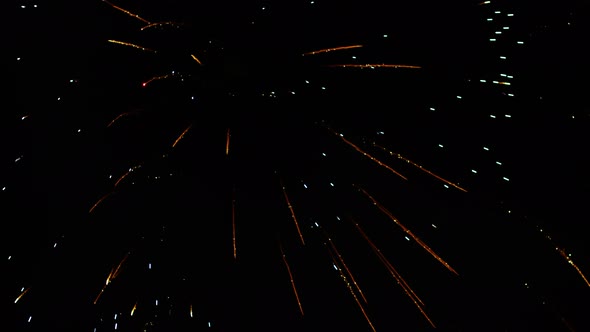 Gold and Green Fireworks Isolated on a Black Background alt