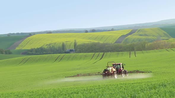 Tractor Spraying Fertilizer on Spring Field