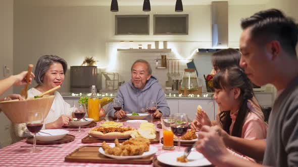 Happy family, Asian big family having small party eating food on dining table together at home. alt