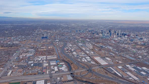 Aerial view of a Downtown Denver looking down from a small airplane flying over I-25. alt
