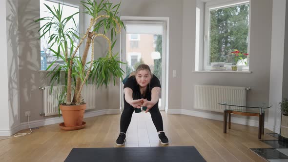 Wide Shot Portrait of Confident Caucasian Plussize Woman Bending Forward Looking at Camera and alt