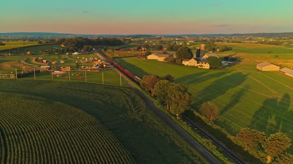 Aerial View of A Steam Passenger Train Approaching Passing Thru a Corn Maze and Corn Fields alt