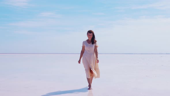 Attractive Woman Smiling Going Barefoot on Water alt