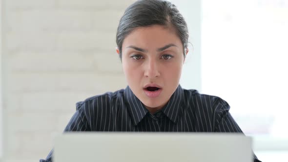 Close Up of Indian Woman with Laptop Reacting to Loss alt