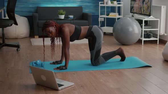 Athletic Sport Black Woman Doing Morning Fitness Routine Watching Fitness Workout Video alt