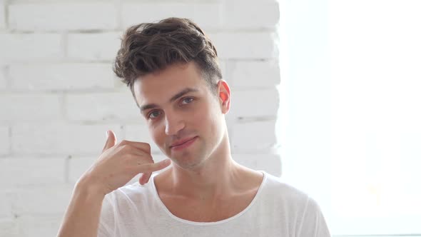 Call Us , Young Man in Office Gesturing Help alt