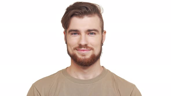 Handsome Caucasian Male with Brown Beard and Khaki Tshirt Smiling on White Background alt