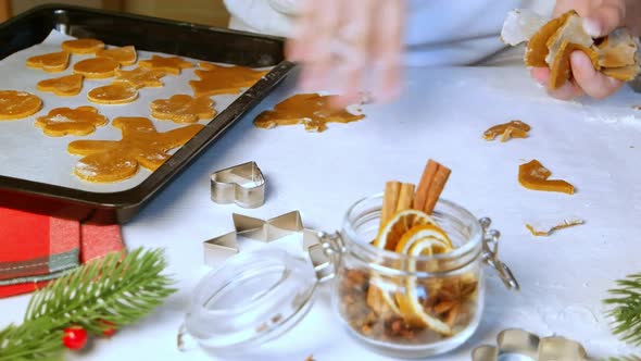 Christmas preparation, child removes extra dough, making gingerbread cookies