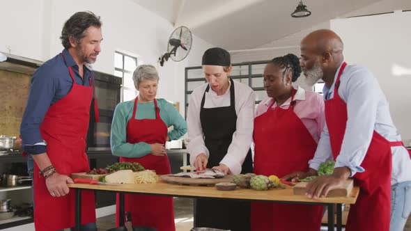 Chefs cooking a fish together alt