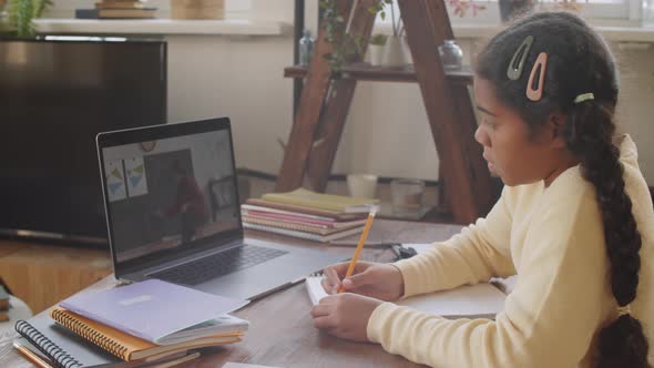 Afro-American Girl Having Online School Lesson via Web Call on Laptop alt