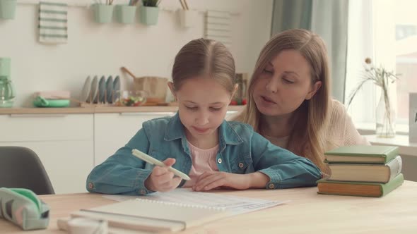 Mother and Her Daughter Doing Homework Together alt