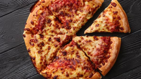 Fluffy Pepperoni Pizza in American Style Placed on Rusty Old Black Wooden Table alt