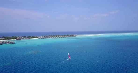 Tropical fly over island view of a sunshine white sandy paradise beach and aqua turquoise water back alt