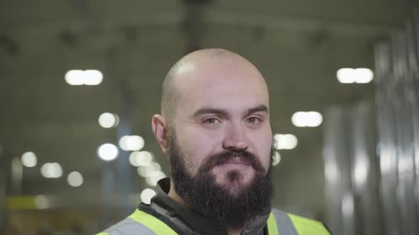 Camera Moving Up, Portrait of Bearded Baldheaded Caucasian Man Smiling at Camera. Happy Worker in alt