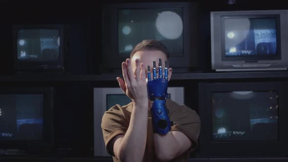 A Disabled Man Blogger Shows Gestures with His Hand and Bionic Prosthesis alt