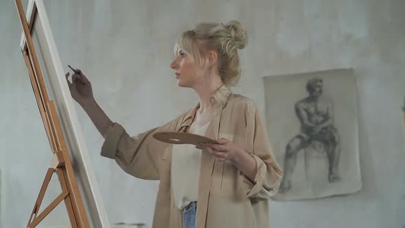 Female Painter Working with Picture in The Art Studio Space