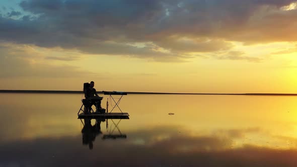 Bright and Colorful Sky in the Background of a Man Playing Hang Drum, Sunset,  alt