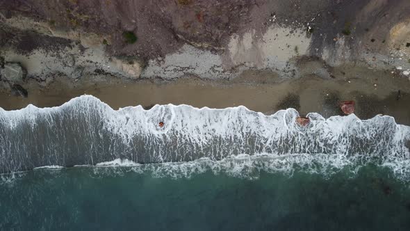 Aerial View From Above on Calm Azure Sea and Volcanic Rocky Shores alt