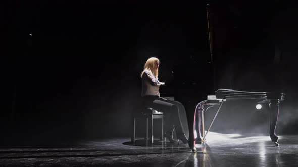 Woman Enthusiastically Plays the Piano alt