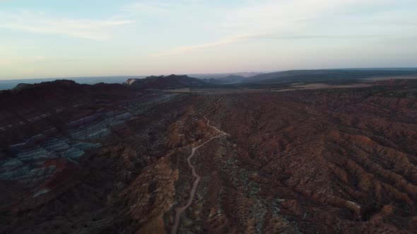 Wide aerial landscape shot of mountainous terrain in a Utah desert. Vermillion Cliffs, Old Paria Can alt